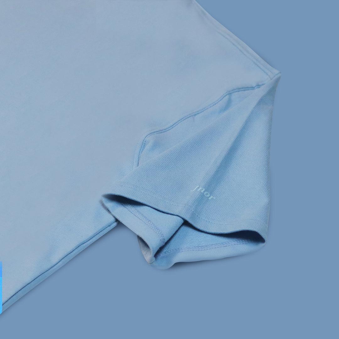 Detailed shot of FNOR Basics sky blue t-shirt sleeve with subtle branding and clean stitching, part of the Basics collection.