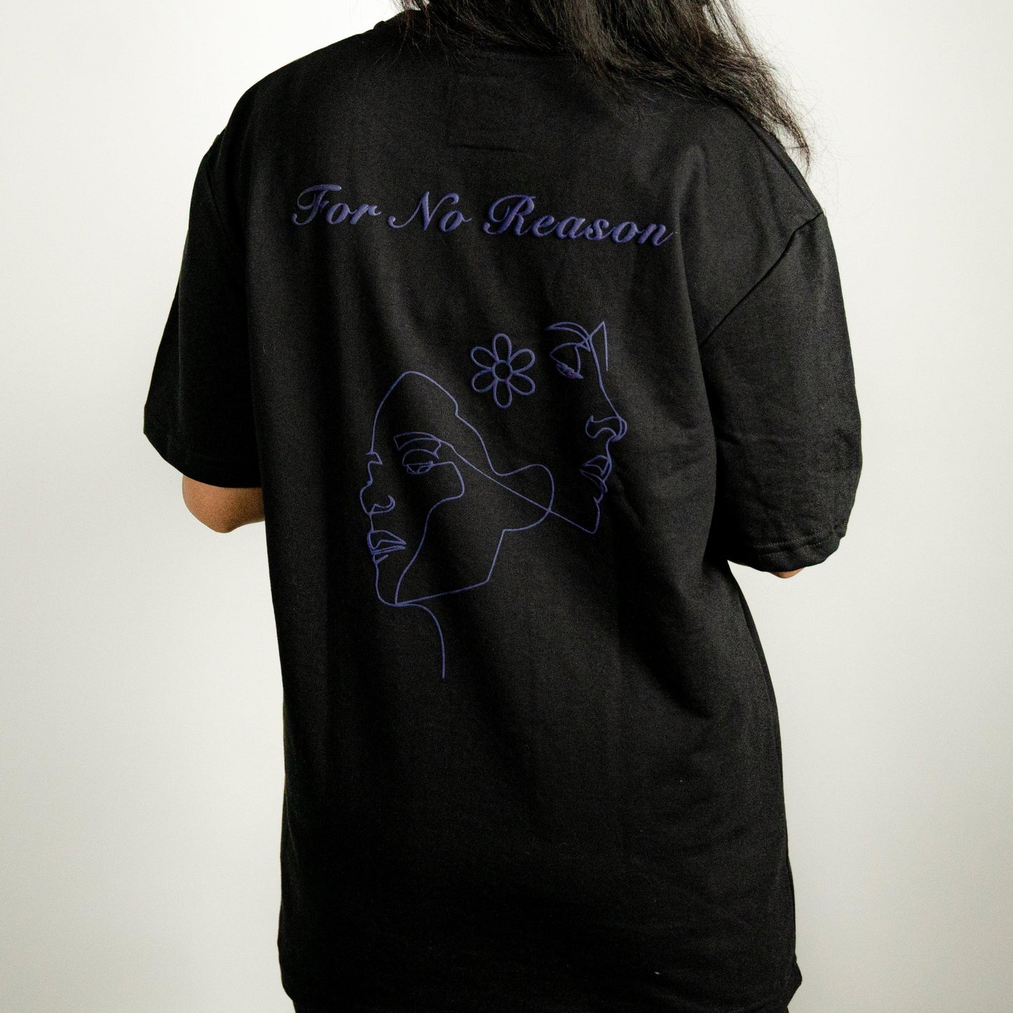 Back view of the FNOR TWO FACE BLACK T-SHIRT, highlighting the artistic dual-face graphic and “For No Reason” text in purple from the Minimalist Series collection.