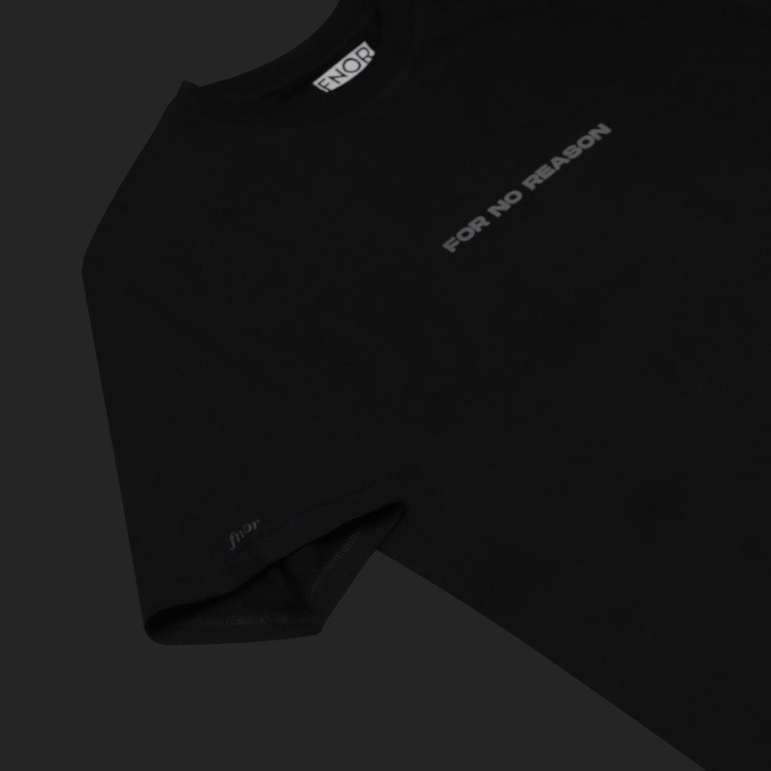 Black FNOR t-shirt laid flat showing the sleeve and “For No Reason” logo in grey.